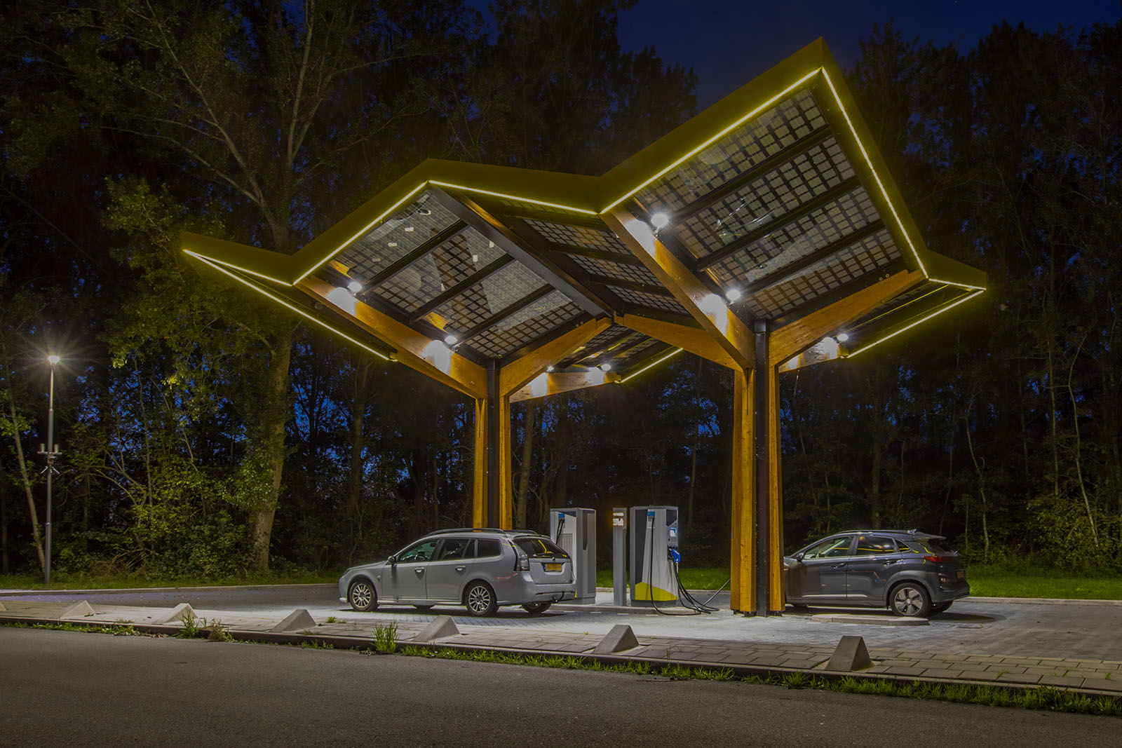 Electric cars charging at electricity filling station in the fast expanding car charging network in the Netherlands